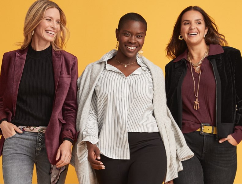 Three models from the front cover of the Fall 2023 Look Book wearing denim, blouses, and accessories from the new collection