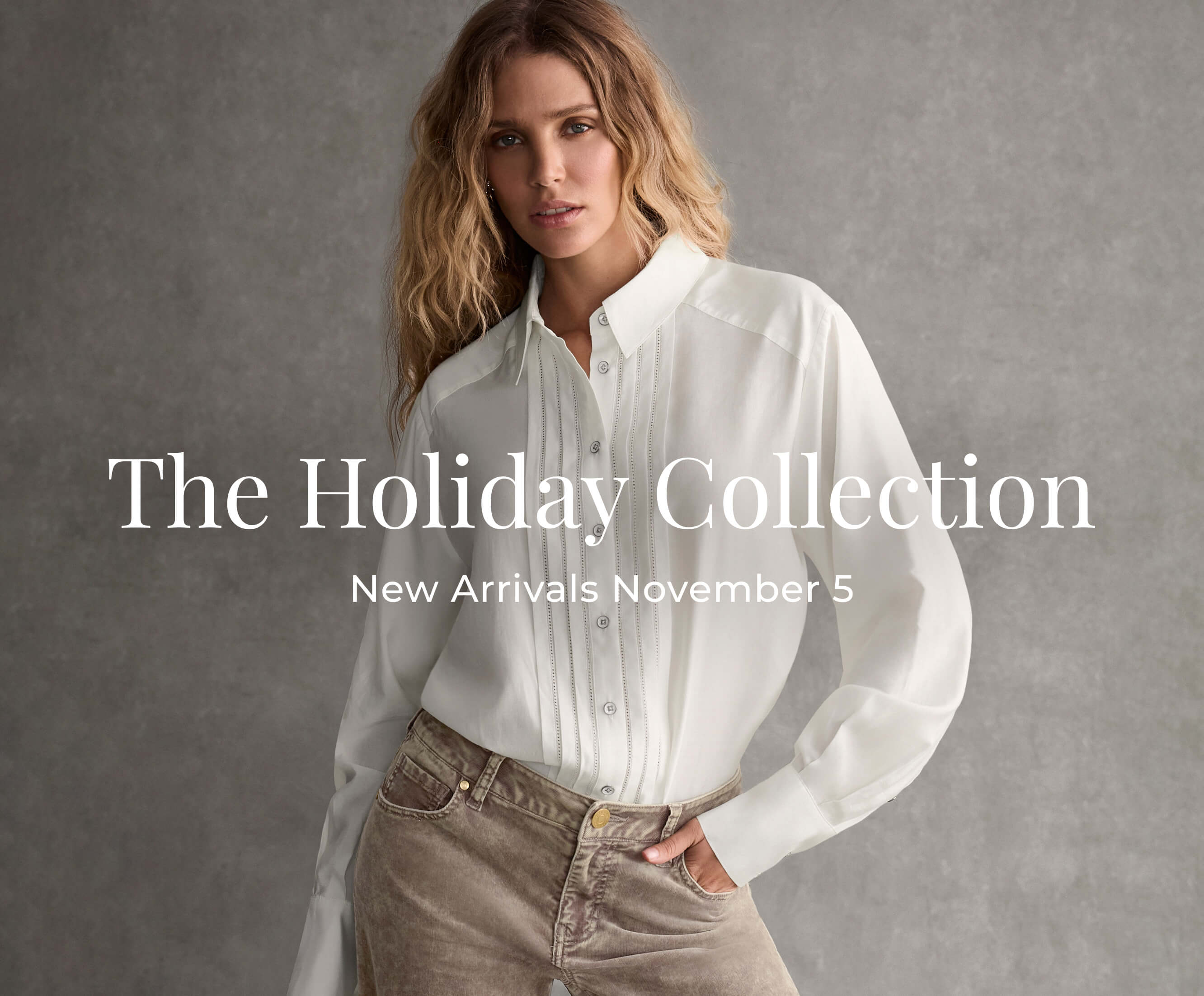 A female model wearing a white long sleeved shirt.