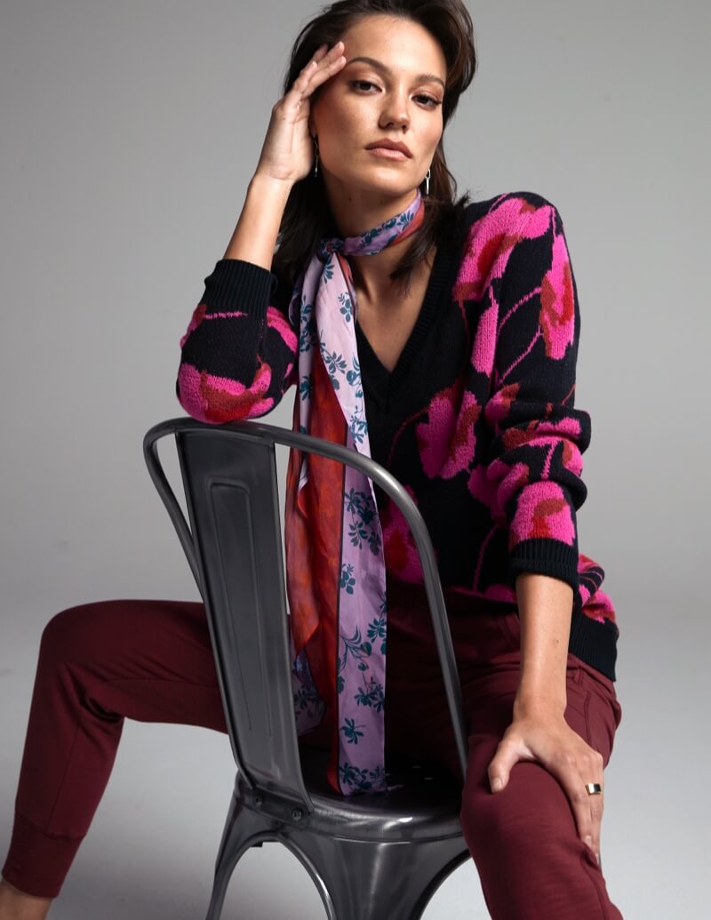 Model wearing Coy Scarf in Multi, Rococo Pullover in Poppy Bloom, Training Jacket in Burgundy.