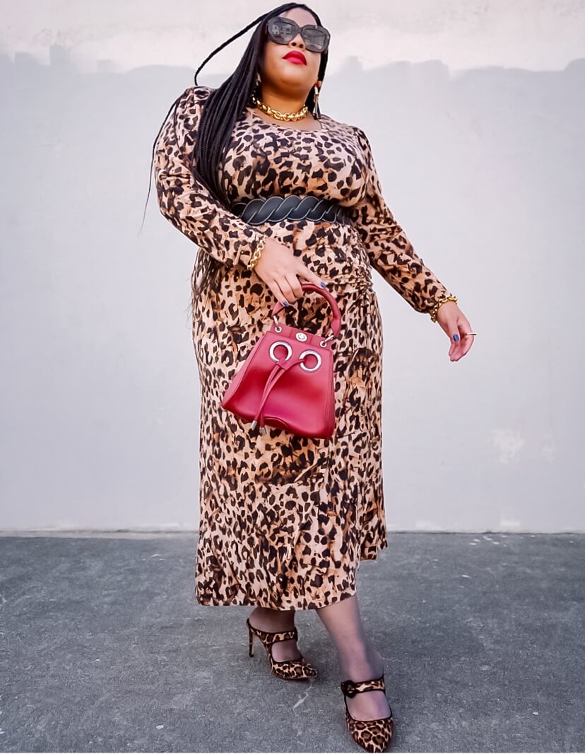 Fashion influencer wearing the Selma Dress in Skin Print and statement accessories.