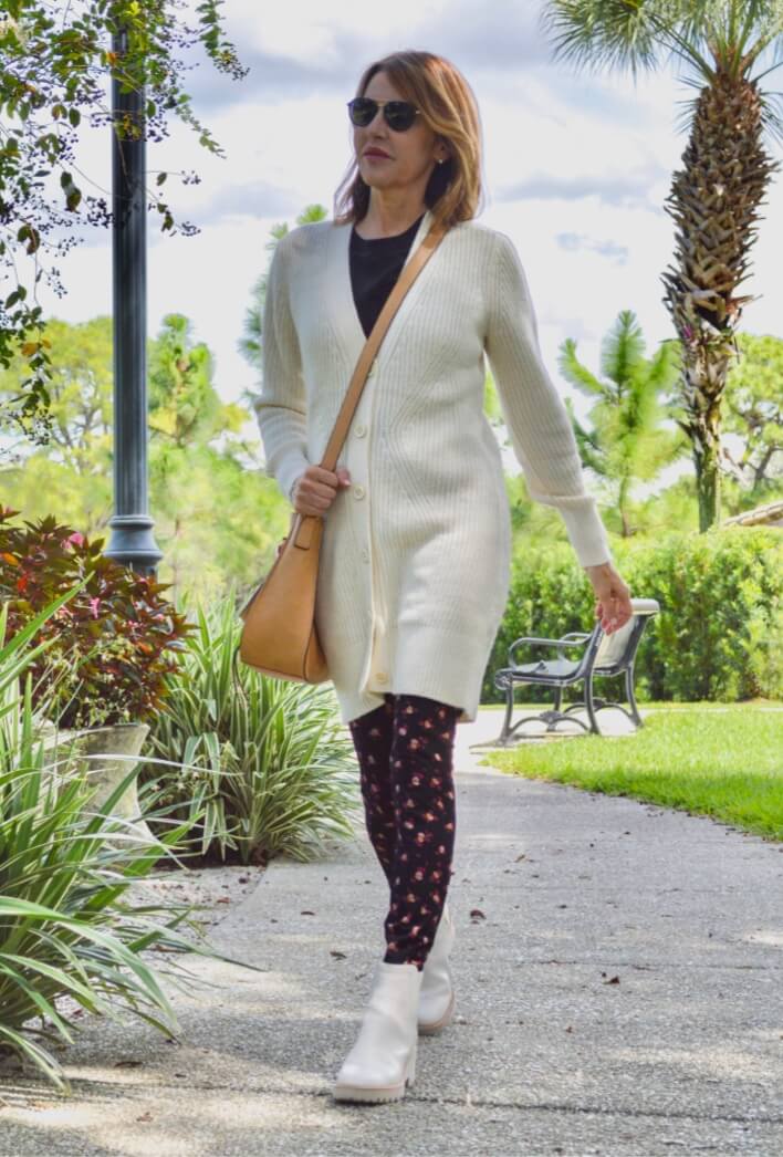 Fashion influencer wearing the Book Club Cardigan in Ivory, Complete Top in Black, and the Printed Lean Legging in Flower Burst.