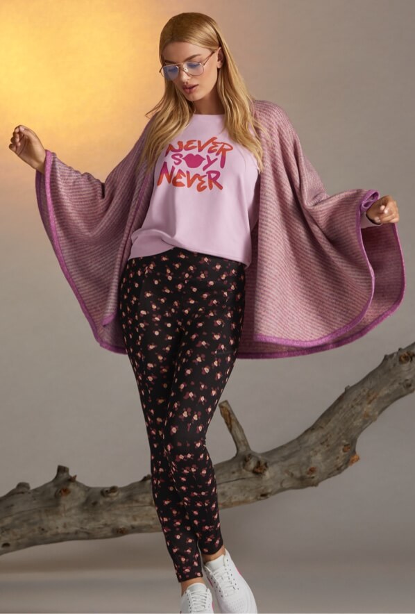 Model Wearing the NSN Sweatshirt in Lilac, Printed Lean Legging in Flower Burst, and Harper Cape in Rose Ombre.