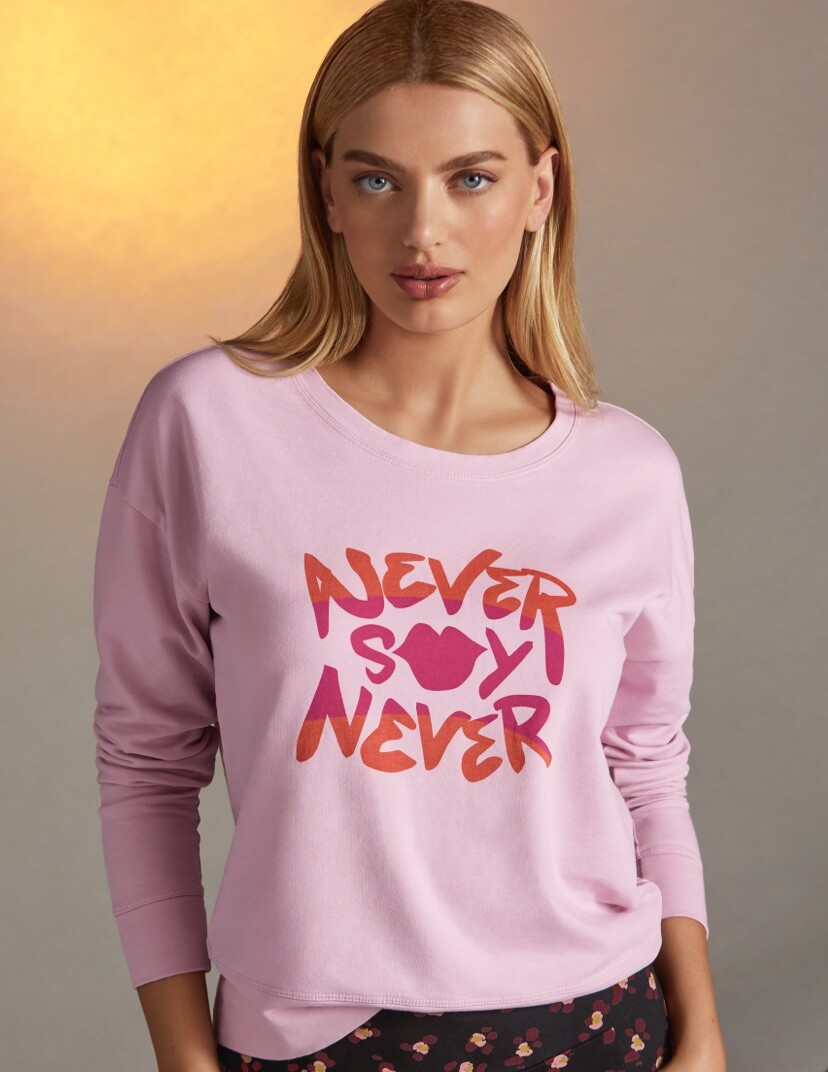 Model Wearing NSN Sweatshirt in Lilac and the Printed Lean Legging in Flower Burst.