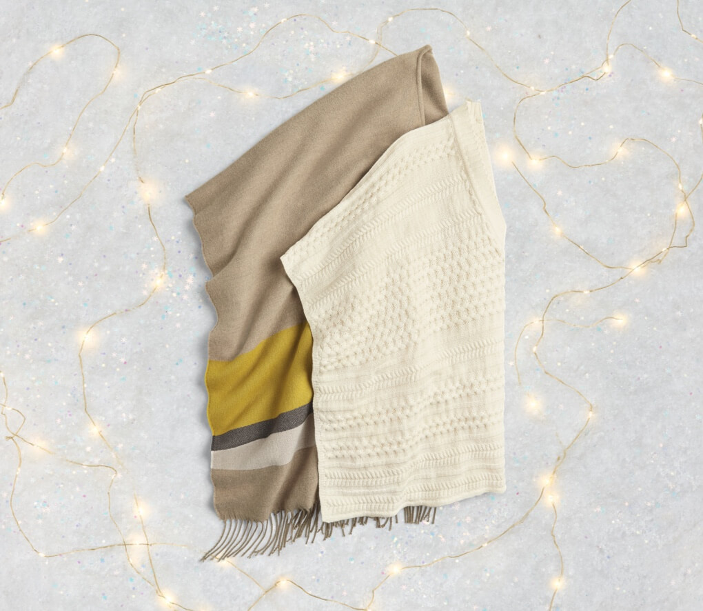 Travel Cape in Heather Stripe, and Winter Poncho in Winter White.