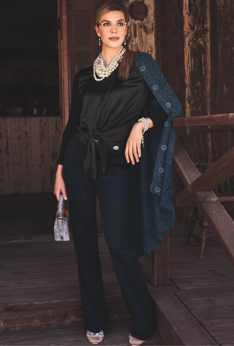 Model wearing Trail Cardigan in Multi Navy, Crosstie Pullover in Black, Checkout Trouser in Blue Check, Dazzle Earrings in Silver, and Dazzle Necklace in Silver