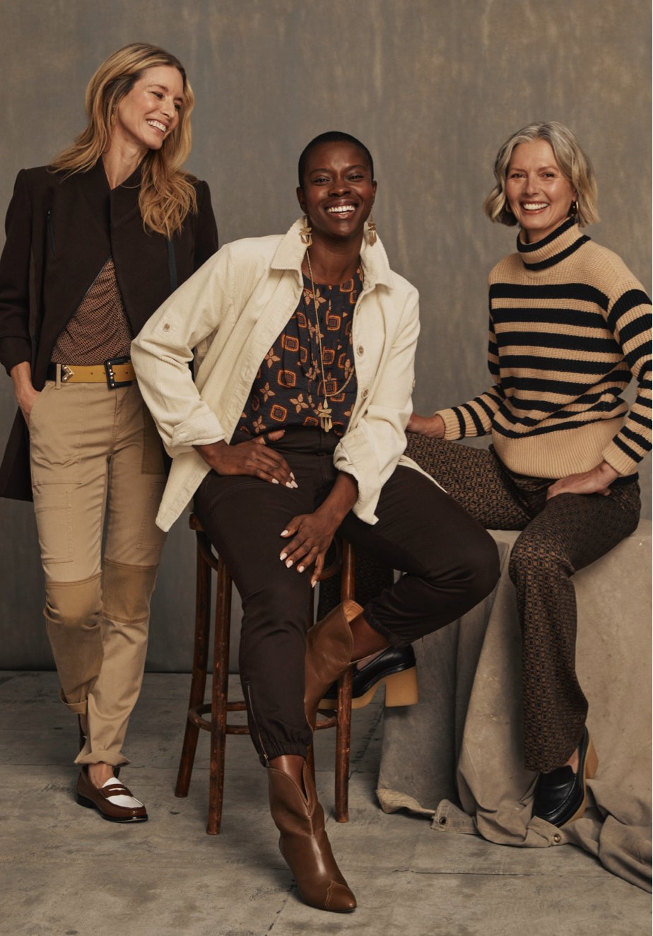 First model is wearing Sassy Top in Tile Print, Legacy Topper in Dark Chocolate, Captain Pant in Khaki, and Ornament Belt in Black Combo.Second model is wearing Louis Top in Medallion Print, Scout Jacket in Bone, and Compass Pant in Dark Chocolate. Third model is wearing Polo Turtleneck in Black and Cream and Director Trouser in Multi.