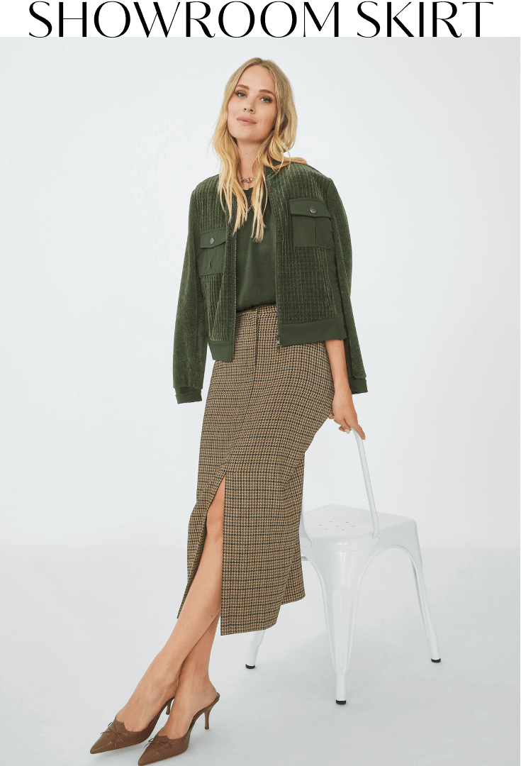 Model wearing Showroom Skirt in Houndstooth, Complete Top in Olive, Uni Jacket in Olive, and Smith Necklace in Silver and Gold.