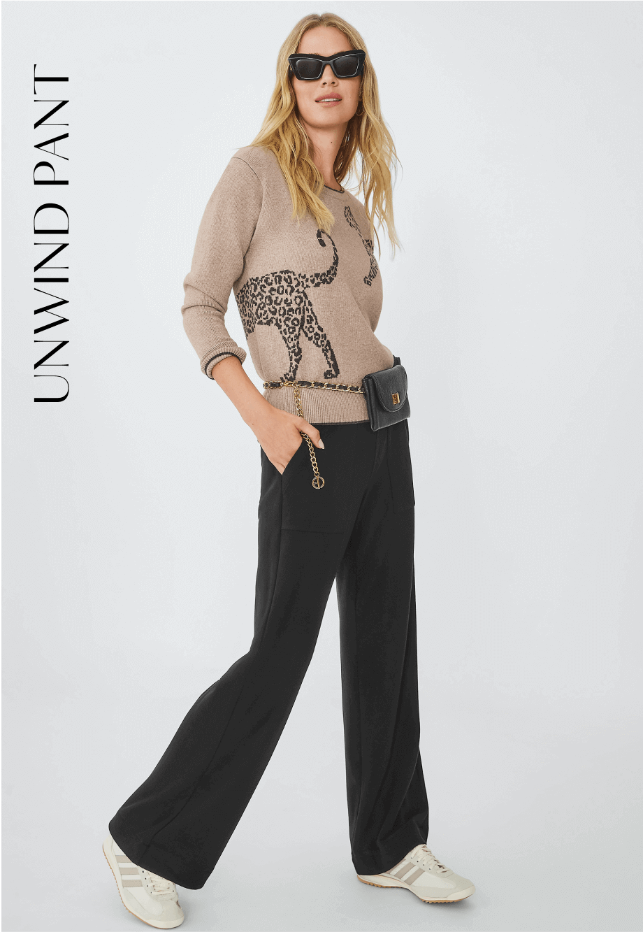 Model wearing Unwind Pant in Black and Cheetah Pullover in Animal.