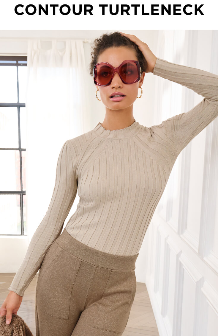 Model wearing Contour Turtleneck in Platinum, Sparkles Sweater in Silver Lining, Book Club Pant in Caramel and Chain Hoop Earrings.