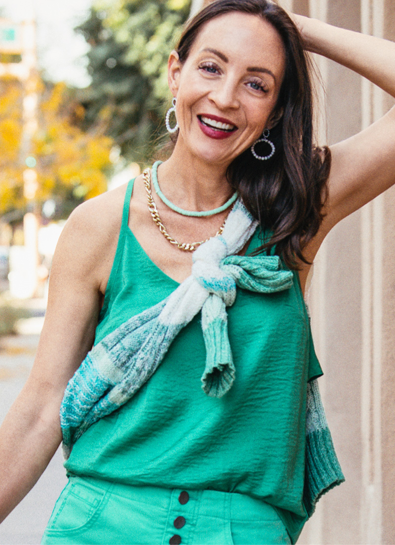 cabi Stylist wearing Park Cami in Verdant, Button Fly Short in Waterfall, Mix Stitch V-Neck in Julep Stripe and Adventure Necklace in Multi-Stone, and Adventure Hoop Earrings in Multi-Stone.